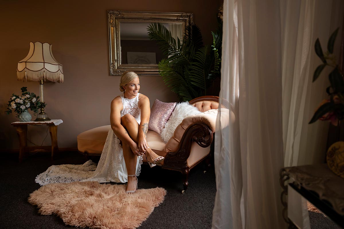 bride putting on shoes at bidja estate wedding 